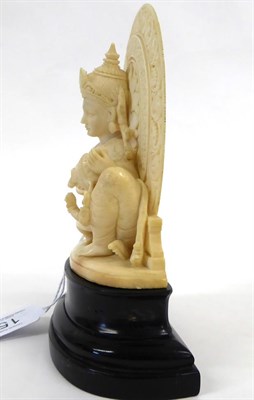 Lot 158 - An Indian Carved Ivory Group, late 19th/early 20th century, as a deity sitting before a halo...