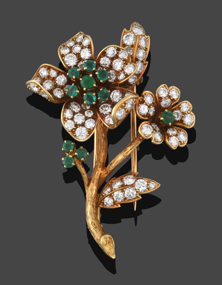 Lot 216 - An Emerald and Diamond Flower Clip/Brooch, the flower centres formed of round cut emeralds to...
