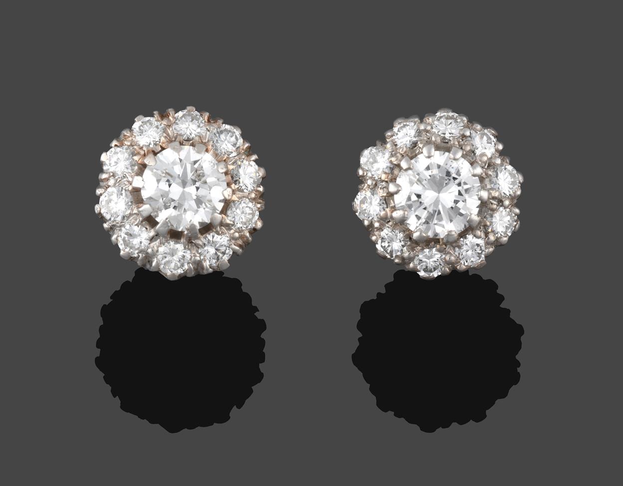 Lot 220 - A Pair of Diamond Cluster Earrings, a raised central round brilliant cut diamond within a border of