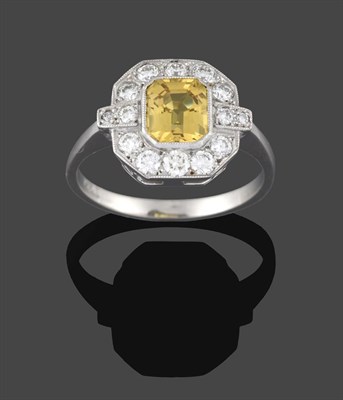 Lot 223 - An Art Deco Style Yellow Sapphire and Diamond Ring, the central emerald-cut yellow sapphire...