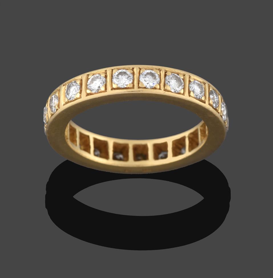 Lot 243 - An 18 Carat Gold Diamond Eternity Ring, twenty-one round brilliant cut diamonds in yellow claw...