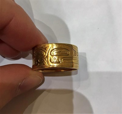 Lot 245 - A Canadian Band Ring, the yellow band engraved with an abstract pattern, finger size Q see...