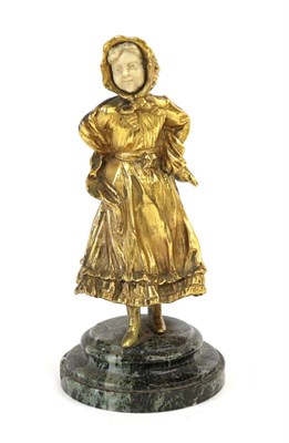 Lot 247 - A Gilt Bronze and Ivory Figure of a Girl, early 20th century, standing wearing a bonnet and...