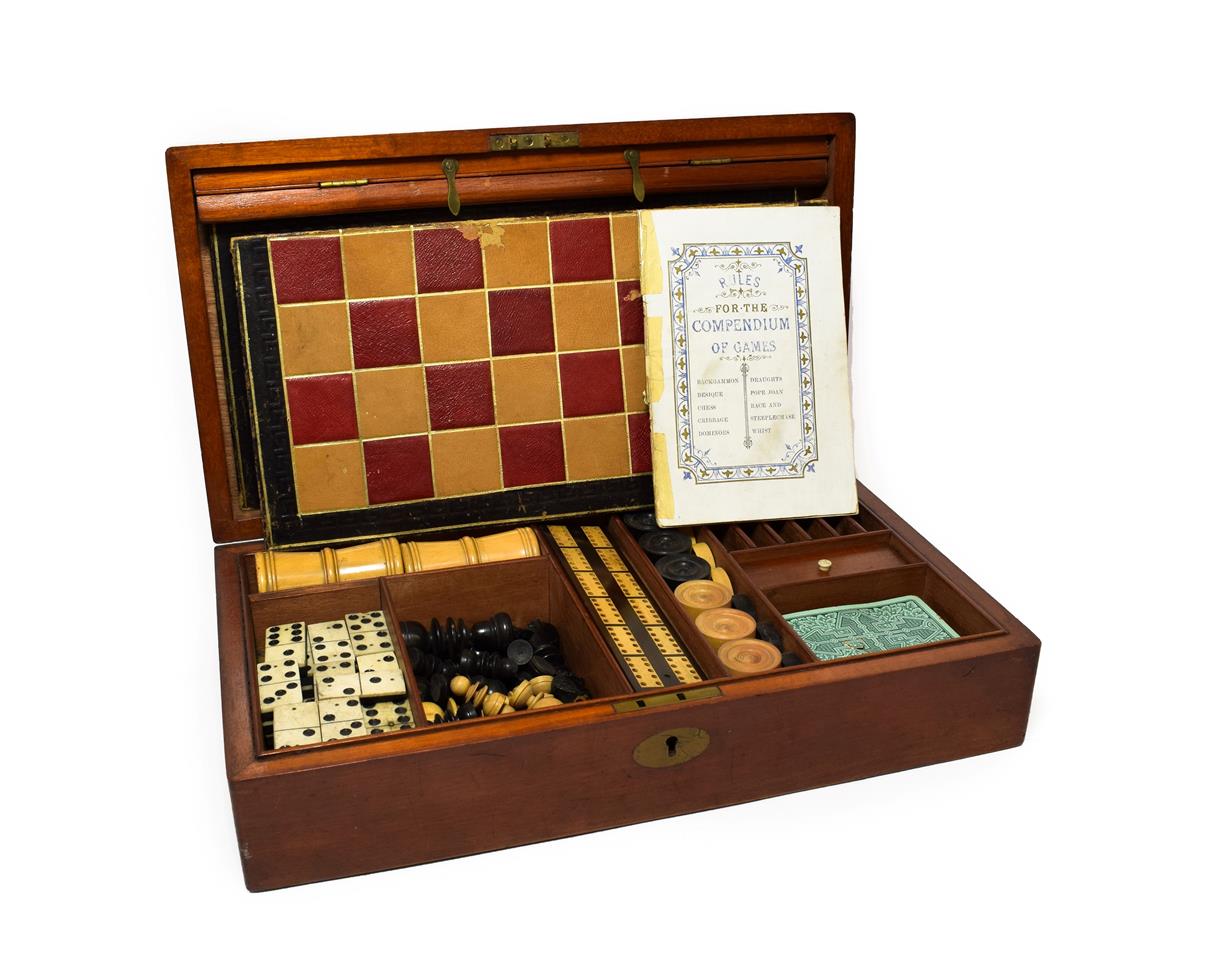 Lot 310 - A Victorian Mahogany Cased Games Compendium, of rectangular form, containing two boards with...