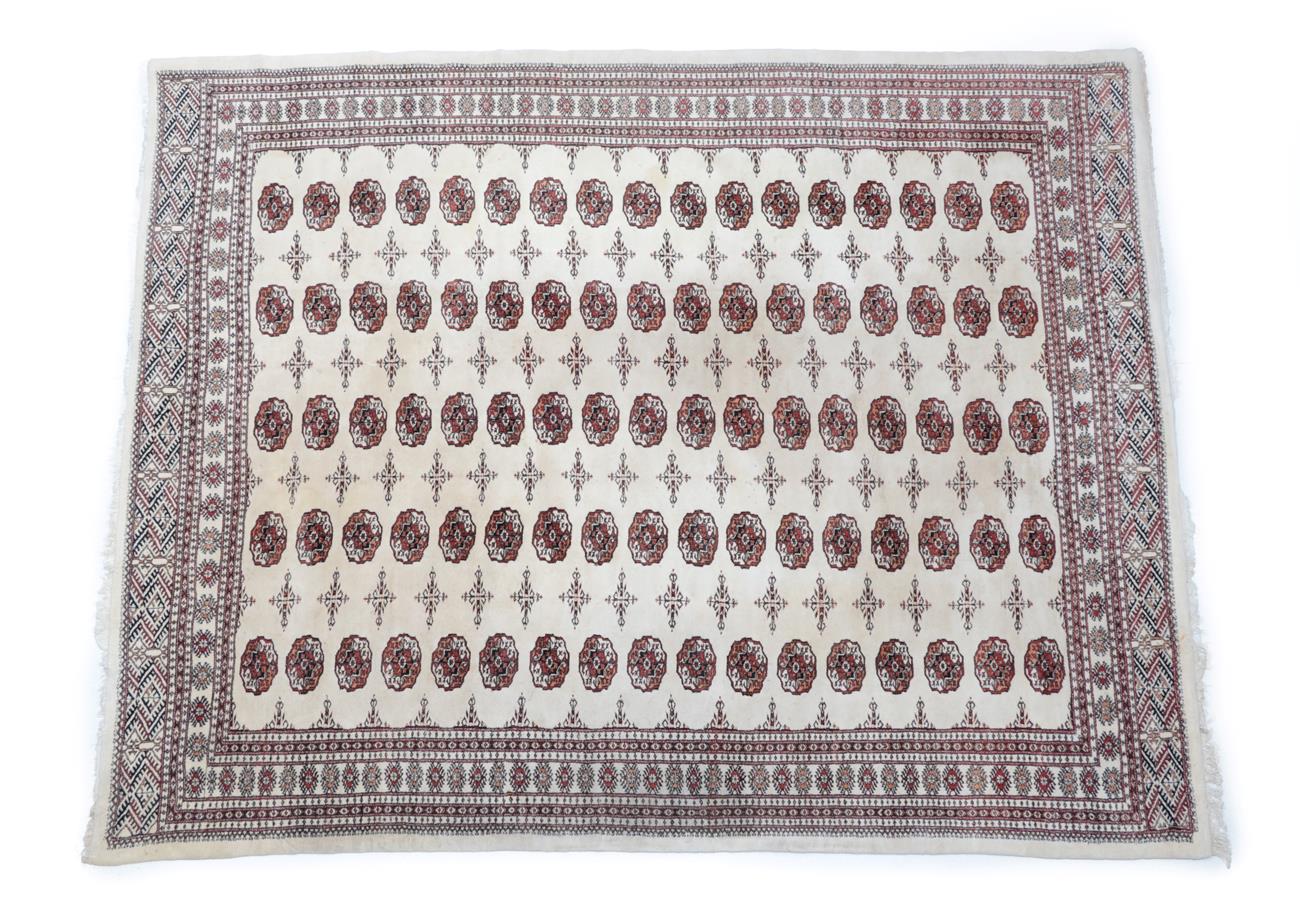 Lot 501 - Afghan ''Bukhara'' Carpet, circa 1970 The cream field with columns of quartered güls enclosed...