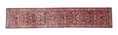 Lot 502 - Narrow Saroukh Runner West Iran, circa 1980 The coral pink field with columns of...
