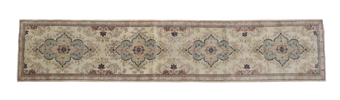 Lot 503 - Narrow Kashan Runner Central Iran, 2nd half 20th century The ivory field with four flowerhead...