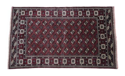 Lot 504 - Turkmen Carpet North Afghanistan, circa 1960 The aubergine field with columns of quartered...
