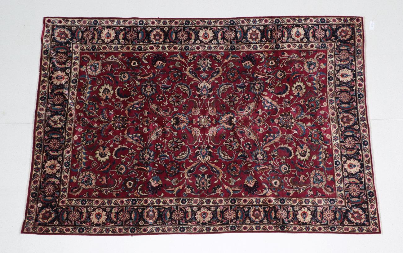 Lot 506 - Mashad Carpet North East Iran, circa 1950 The raspberry field of palmettes and scrolling vines...