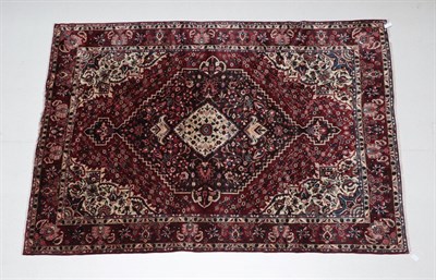 Lot 507 - Bakhtiari Carpet West Iran, circa 1960 The deep brick red field centred by a stepped floral...