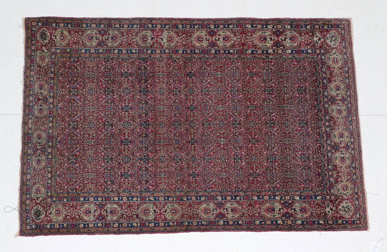Lot 513 - Central Iranian Rug Possibly Tehran or Isphahan, circa 1930 The raspberry floral lattice field...