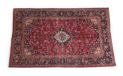 Lot 516 - Kashan Carpet Central Iran, circa 1960 The crimson field of curvilinear vines around an indigo...