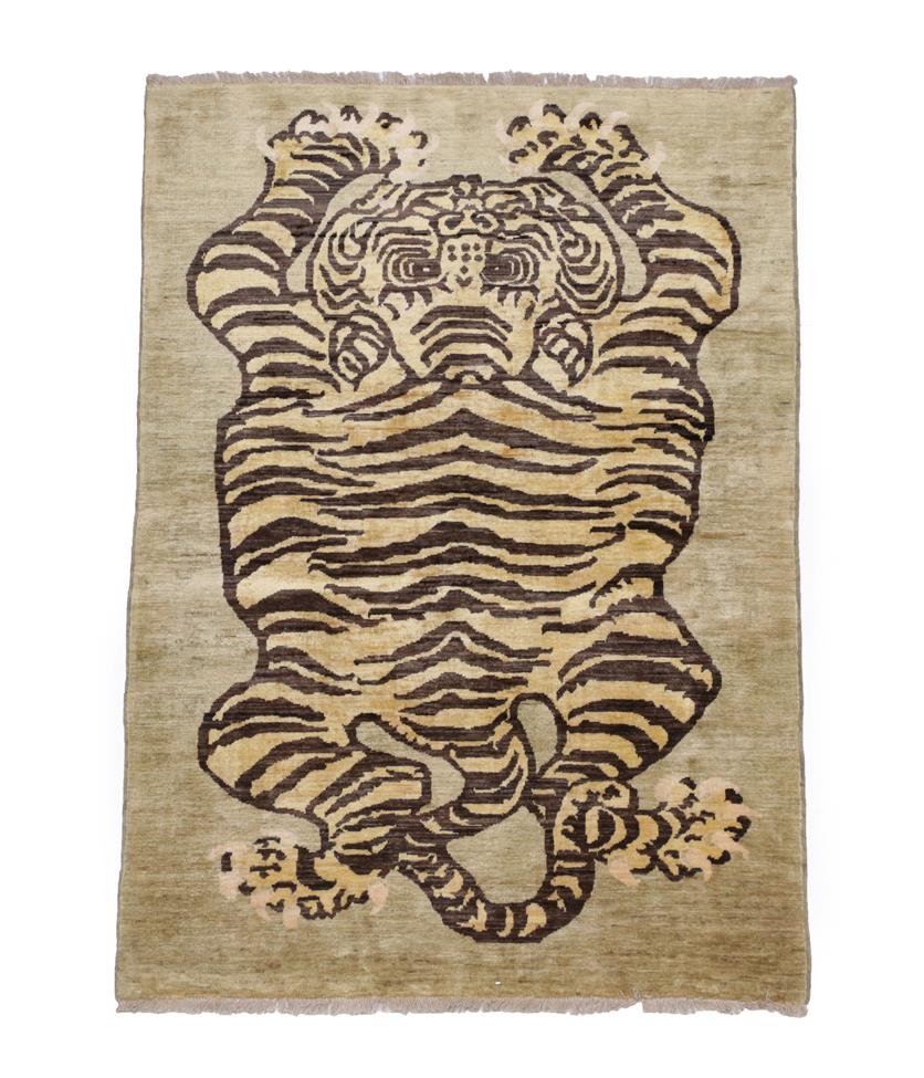 Lot 527 - Tibetan/Nepali Tiger Rug, circa 2010 The tiger in semi naturalistic form on a shaded ground,...