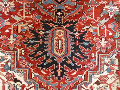 Lot 531 - Heriz Carpet North West Iran, circa 1920 The blood red field of angular vines and stylised...