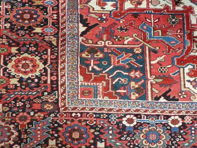 Lot 531 - Heriz Carpet North West Iran, circa 1920 The blood red field of angular vines and stylised...