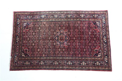 Lot 532 - Hamadan Carpet Iranian Kurdistan, 20th century The blood red Herati field centred by a...