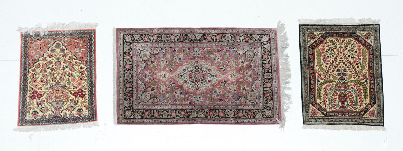 Lot 545 - Small Ghom Silk Rug Central Iran, circa 1970 The ivory field centred by an urn issuing flowers...