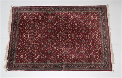 Lot 550 - Lahore Carpet Punjab, 20th century The burgundy field of millefleur design enclosed by indigo...