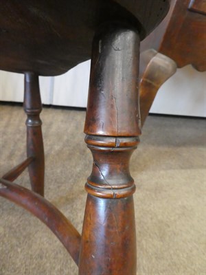 Lot 553 - A Mid 19th Century Yew Windsor Armchair, the double spindle back support with curved arm...