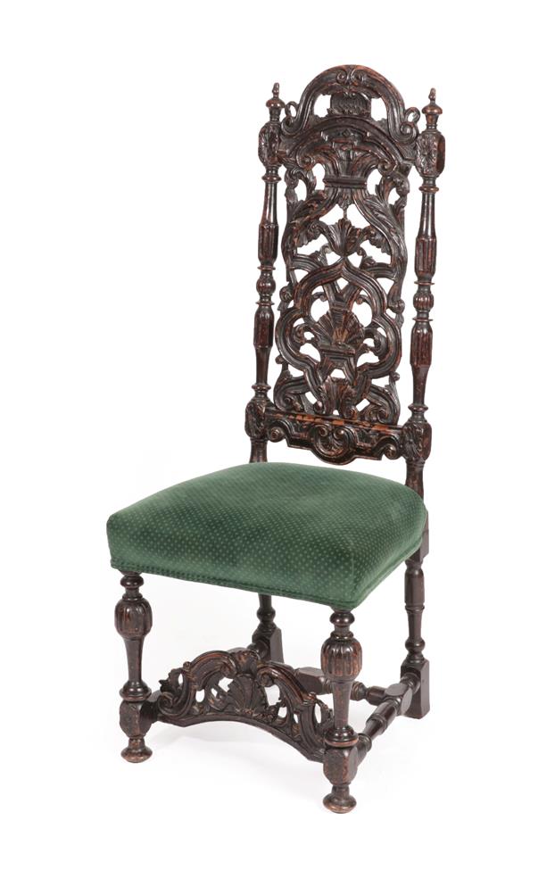 Lot 559 - A 17th Century Carved Walnut High-Back Dining Chair, the scrolled top rail above a pierced and...