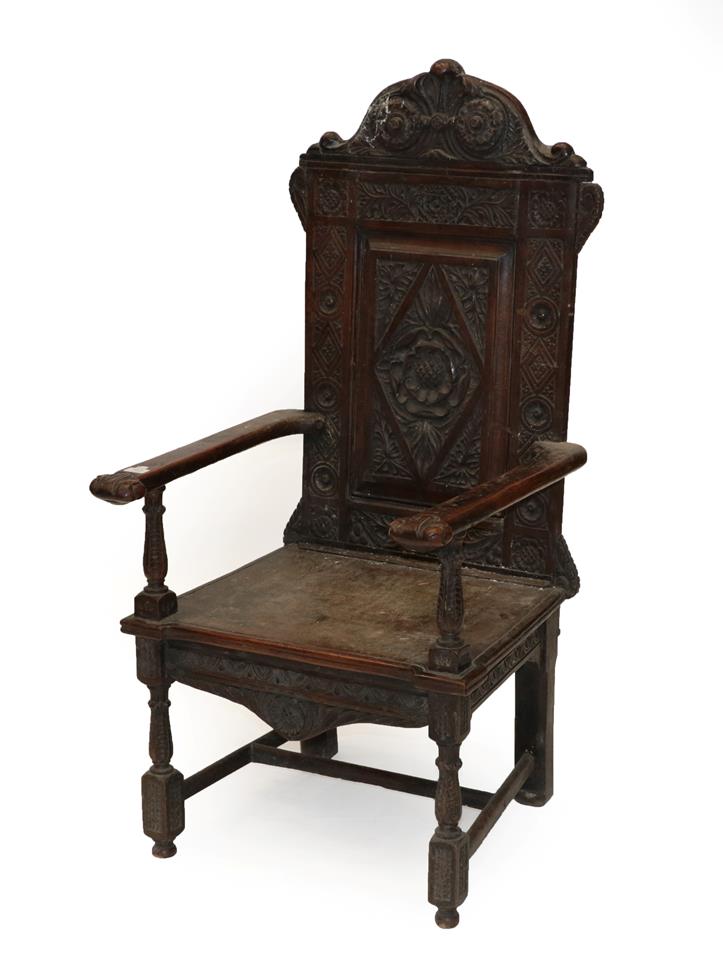 Lot 563 - A Victorian Carved Oak Armchair, late 19th century, with lozenge and rosette carved back...