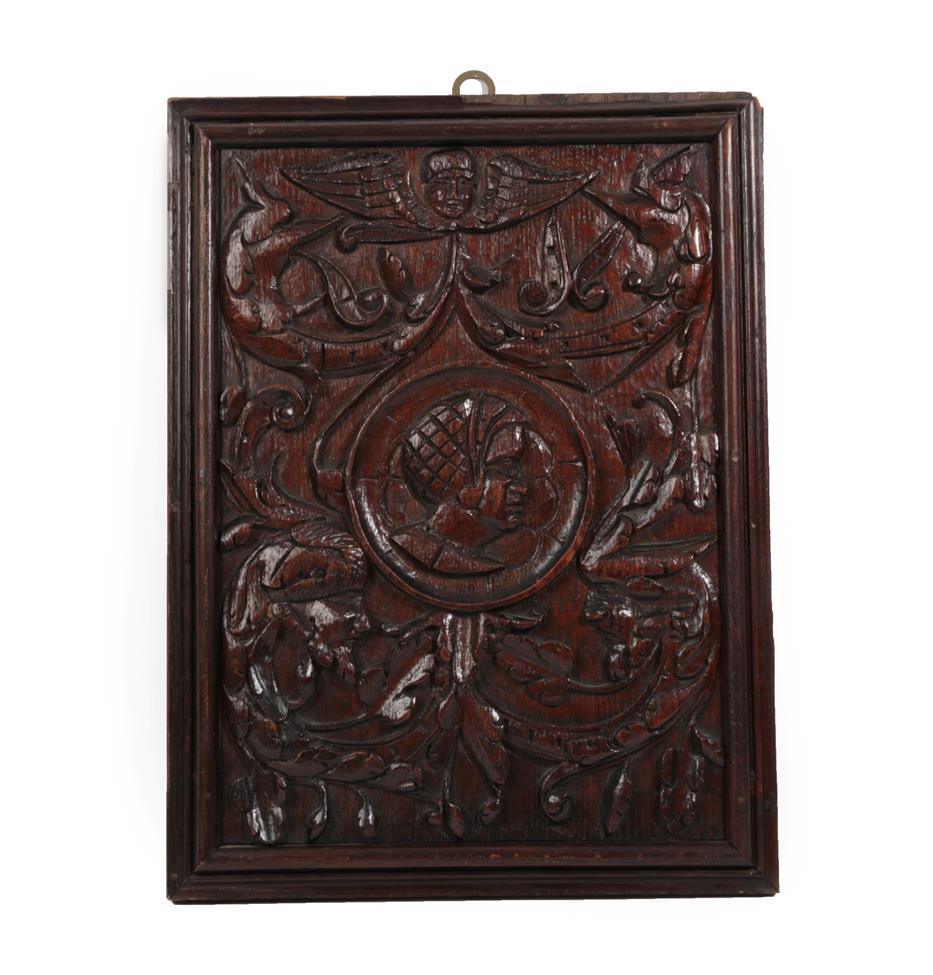 Lot 567 - A Carved Oak ''Romayne'' Type Panel, in 16th century style, the helmeted head in a roundel with...