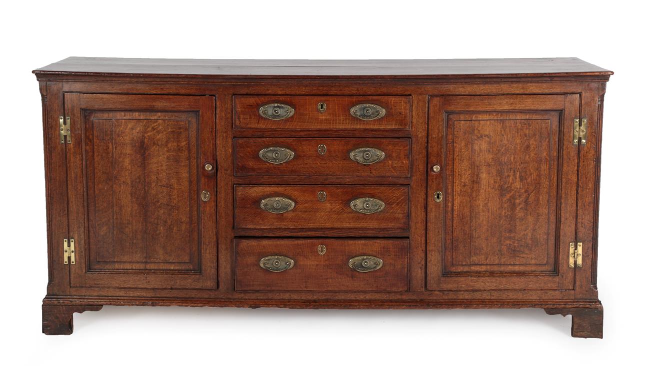 Lot 574 - A George III Oak Enclosed Dresser Base, 3rd quarter 18th century, the moulded top above a...