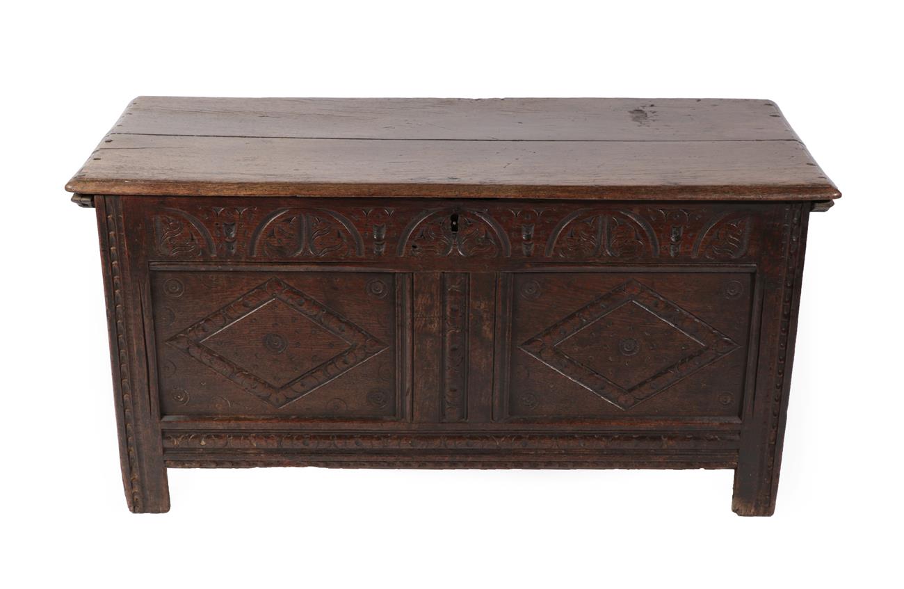 Lot 584 - A Late 17th Century Joined Oak Chest, the hinged lid above a candle box with two lozenge carved...