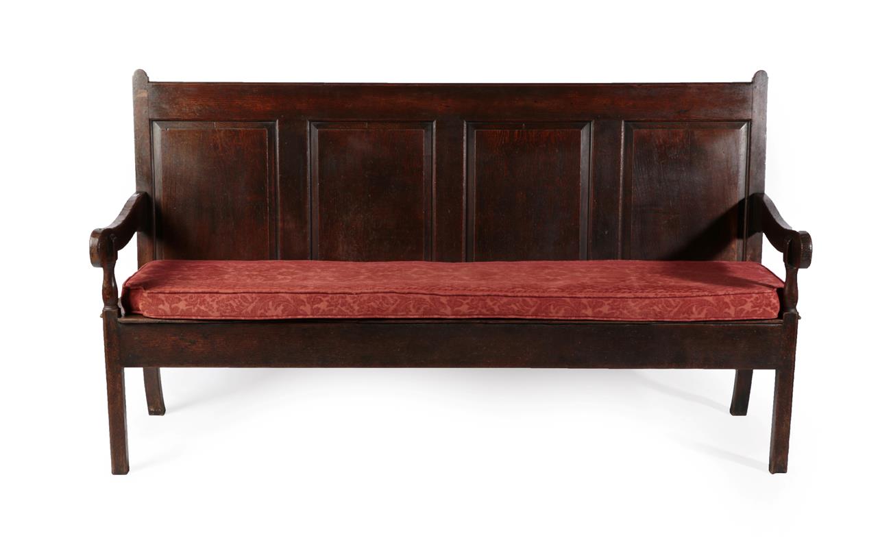 Lot 585 - A George III Joined Oak Settle, early 19th century, the back support with four fielded panels above