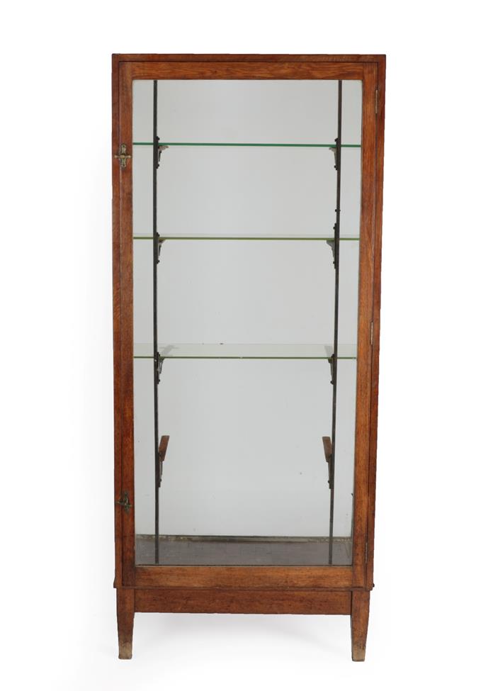 Lot 593 - An Early 20th Century Oak and Glazed Free-Standing Shop Display Cabinet, early 20th century,...