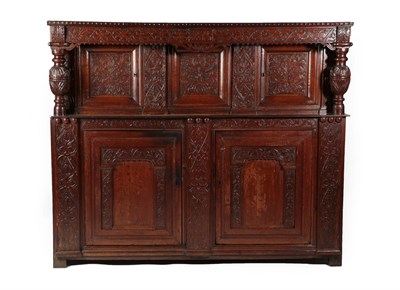 Lot 597 - A 17th Century Joined Oak Press Cupboard, carved and dated ISAAC POSSIT? 1671, the carved...