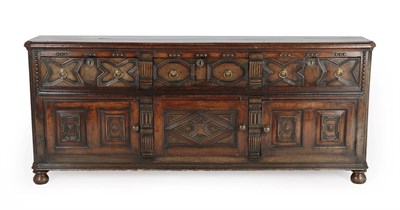 Lot 600 - A Late 17th/Early 18th Century Enclosed Oak Dresser, the crossbanded top above three geometric...
