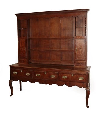 Lot 604 - A Late George III Oak and Mahogany Crossbanded Enclosed Dresser, early 19th century, the dentil...