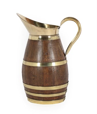 Lot 607 - An Oak and Brass Jug, of staved construction, with rivetted handle, the body with five riveted...