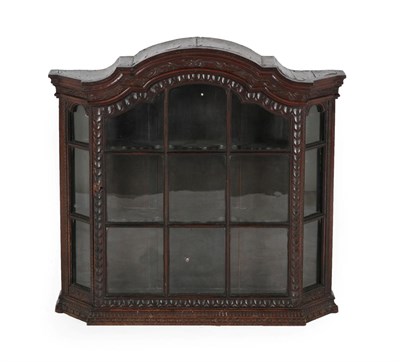 Lot 611 - A Victorian Carved Oak Wall Cabinet, mid 19th century, the moulded cornice above a glazed door...