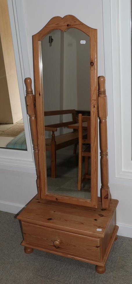 Lot 625 - A Pine Cheval Mirror, the arched rectangular plate within a plain frame pivoting on spindle...