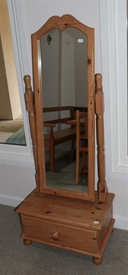 Lot 625 - A Pine Cheval Mirror, the arched rectangular plate within a plain frame pivoting on spindle...