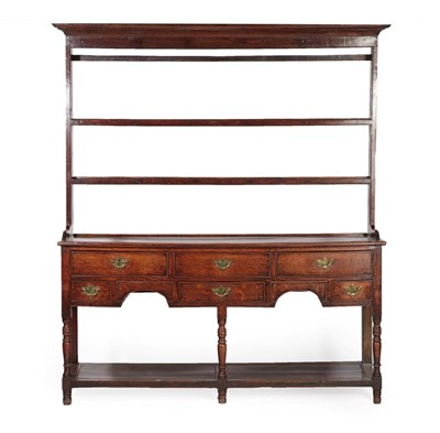 Lot 627 - A George III Oak Open Dresser and Rack, circa 1800, the rack with a bold cornice above two shelves