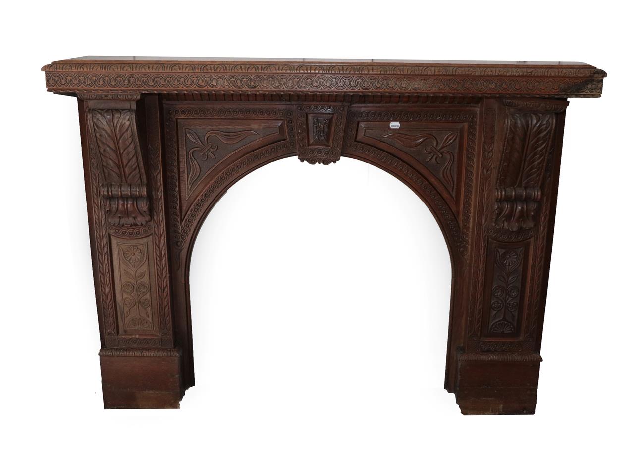 Lot 632 - A Victorian Carved Oak Chimney Piece, in two parts, the mantel shelf carved with a lunette and...