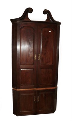 Lot 645 - A George III Mahogany Free-Standing Corner Cupboard, late 18th century, the swan neck pediment with
