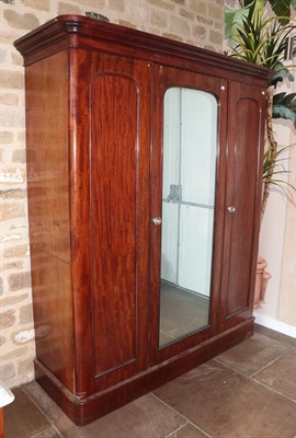 Lot 652 - A Victorian Mahogany Triple Door Wardrobe, late 19th century, the moulded cornice above three...