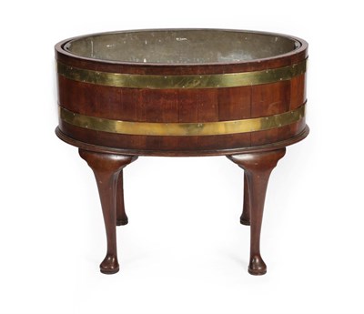 Lot 675 - A George III Mahogany and Brass Bound Oval Cellaret, early 19th century, of staved...