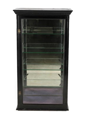 Lot 684 - A Late Victorian Ebonised and Glazed Table Top Shop Display Cabinet, circa 1900, the pivoting...