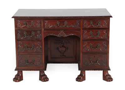 Lot 698 - A Victorian Carved Mahogany Kneehole Desk, late 19th century, the top with stiff leaf carved border