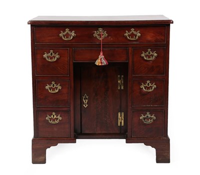 Lot 702 - A George III Mahogany Kneehole Dressing Table, circa 1780, the moulded top above a long frieze...