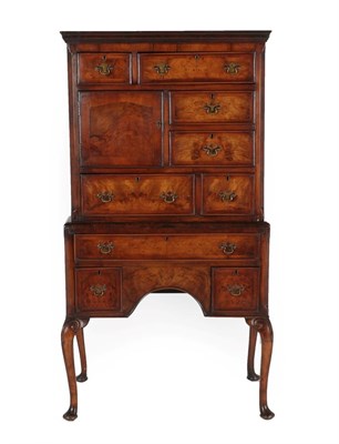 Lot 721 - A 20th Century Walnut Tallboy, the upper section with an arrangement of six drawers around a...