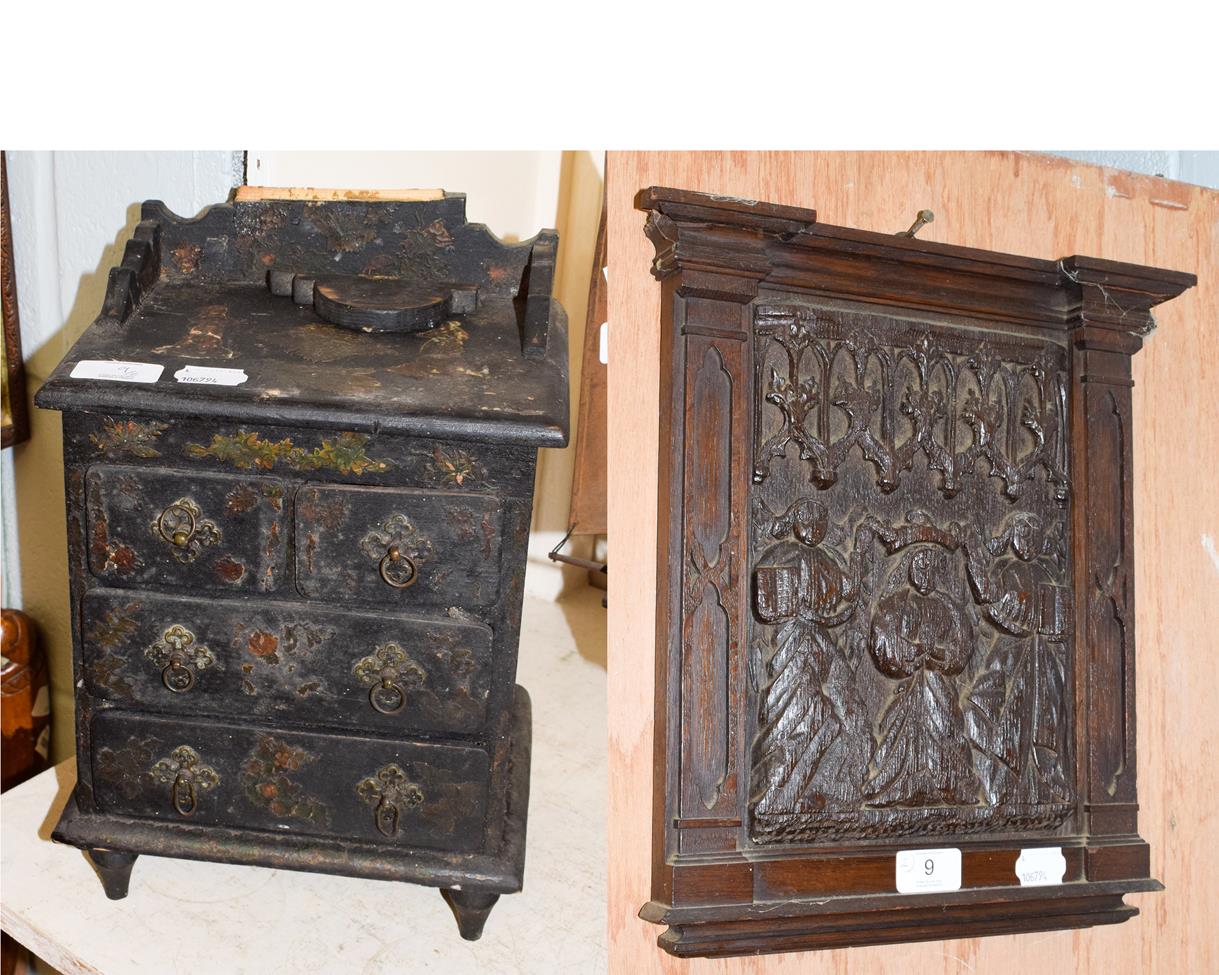 Lot 9 - A 19th century papier mache miniature chest of drawers and a 17th century carved oak panel (2)