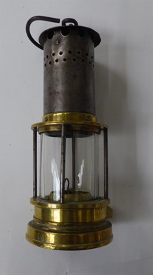 Lot 51 - A Bedlington miners lamp, two Eccles miners lamps, a ships copper lamp and a brass lamp (5)