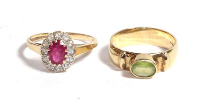Lot 222 - A 9 carat gold peridot ring, finger size N1/2; and a 9 carat gold paste set cluster ring,...