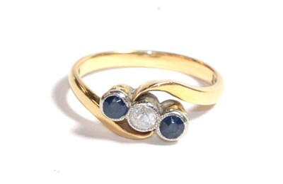 Lot 224 - A sapphire and diamond three stone twist ring, stamped '18CT', finger size L